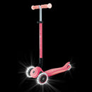 Scooter Globber Elite Glow Lights Coral Pink con las ruedas LED blancas encendidas
